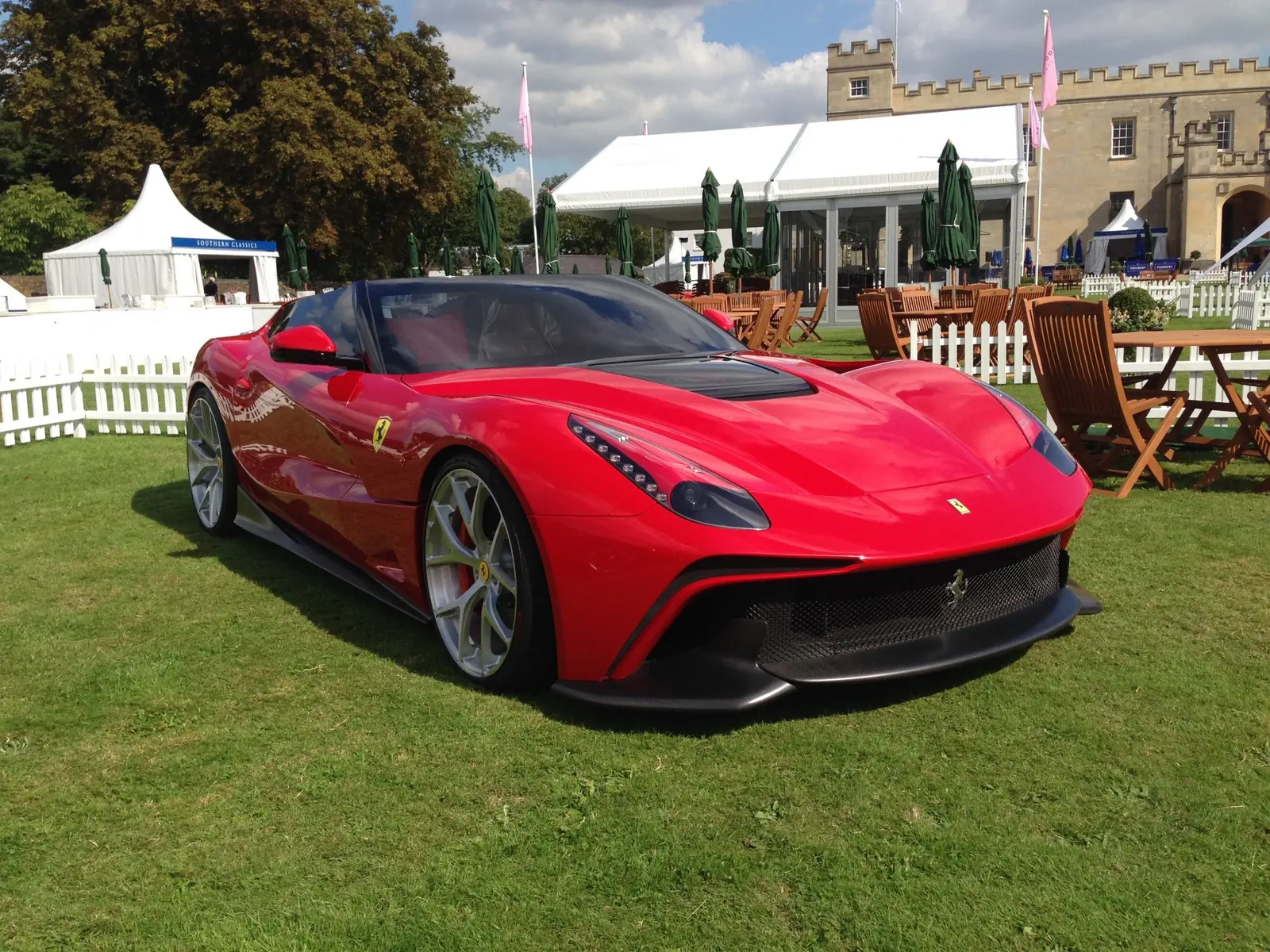 Red Ferrari F12 TRS on a concours lawn
