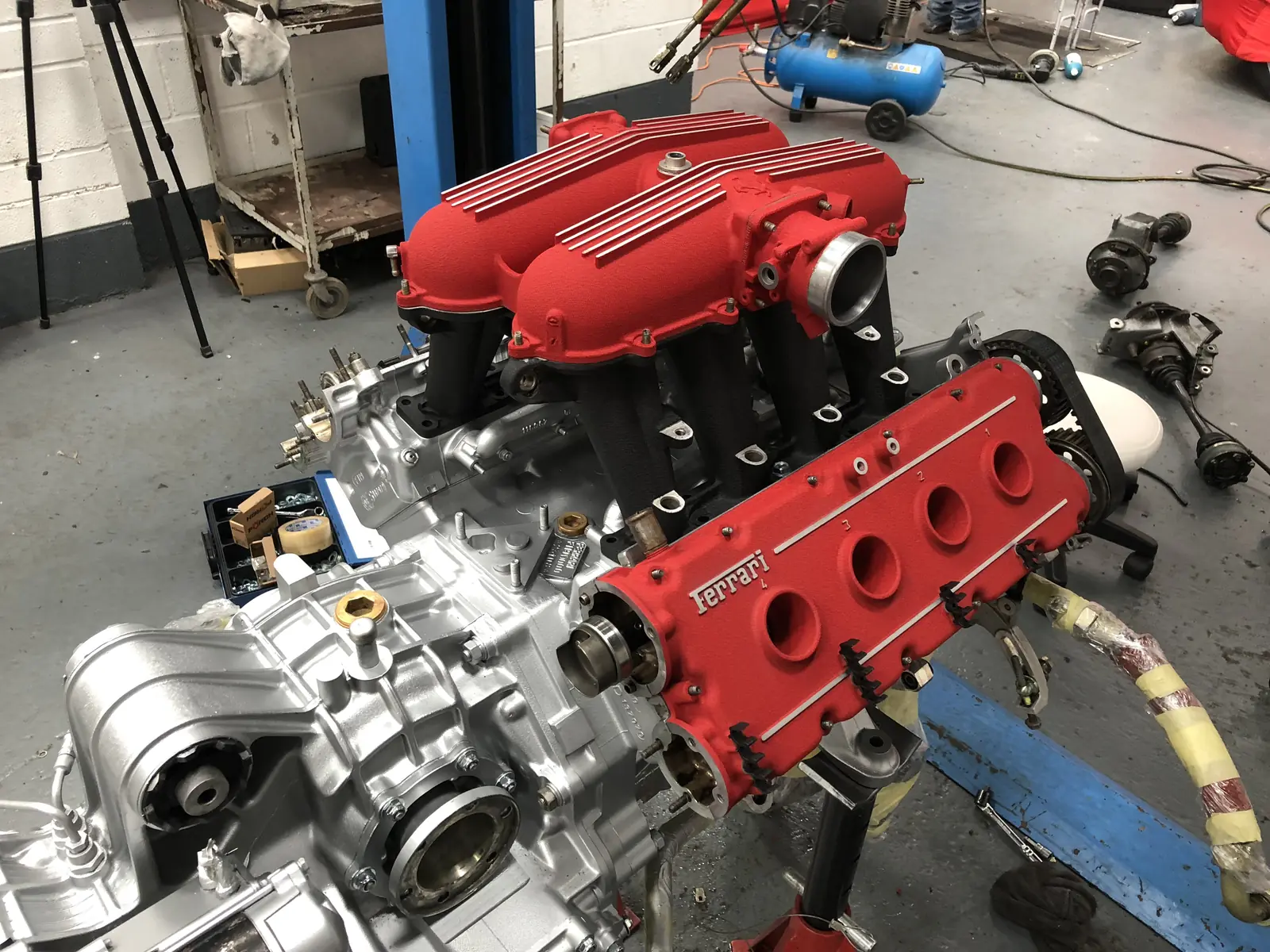 Ferrari V8 engine being detailed out of the car